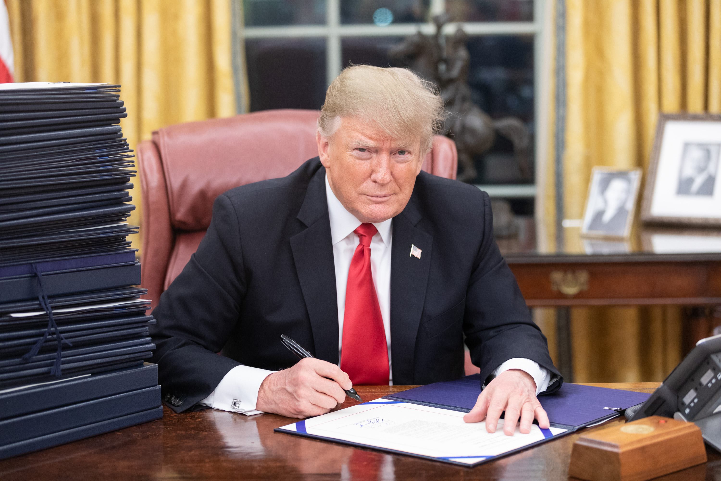 A very serious man at a very serious desk, doing very serious paperwork.